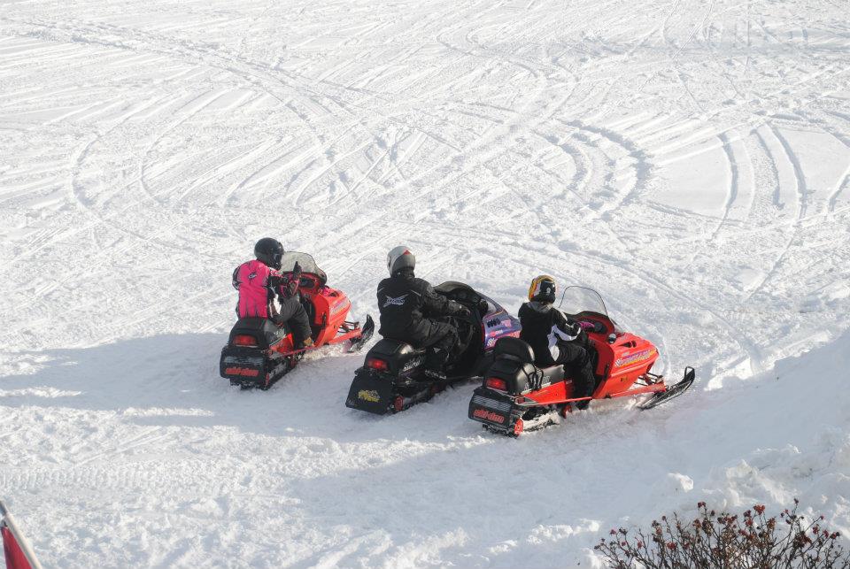 Group of snowmobiles in the Maine snow