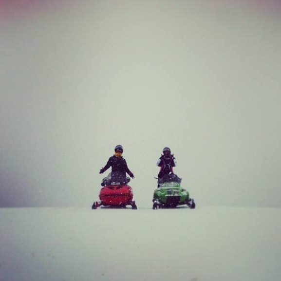 Snowmobiles riding in Maine winter conditions